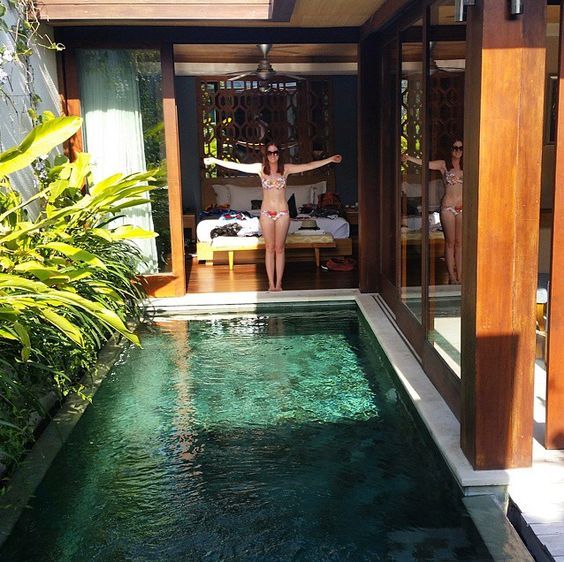 a small backyard pool lined up with greenery and with an entrance right from the bedroom is a wonderful idea