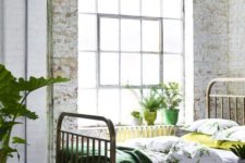 20 an industrial meets vintage bedroom with botanical print bedding and an emerald blanket