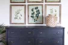 23 a vintage navy sideboard and a gallery wall of vintage botanicals in frames