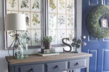 24 a farmhouse entryway with large artworks of botanical prints in frames to highlight the style of the space