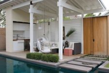 24 a stylish contemporary pool cabana with a living space and a kitchen, with a hanging acrylic chair and potted greenery