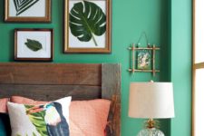 26 a tropical bedroom with a small gallery wall of real leaves that highlights the theme of decor