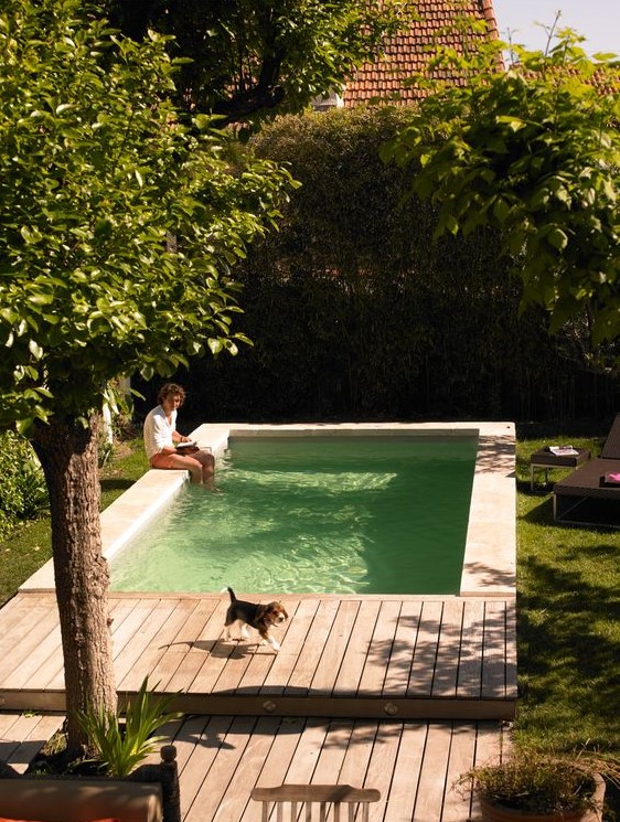 a lovely outdoor space with trees and greenery around, with a plunge pool, a wooden deck is a very cozy space to be in