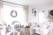 a neutral and pastel farmhouse space with blue chairs, a white sofa, a basket box as a coffee table and a jute rug