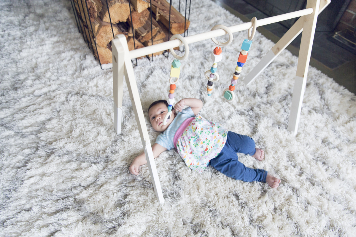 DIY wooden baby gym with colorful geometric beads