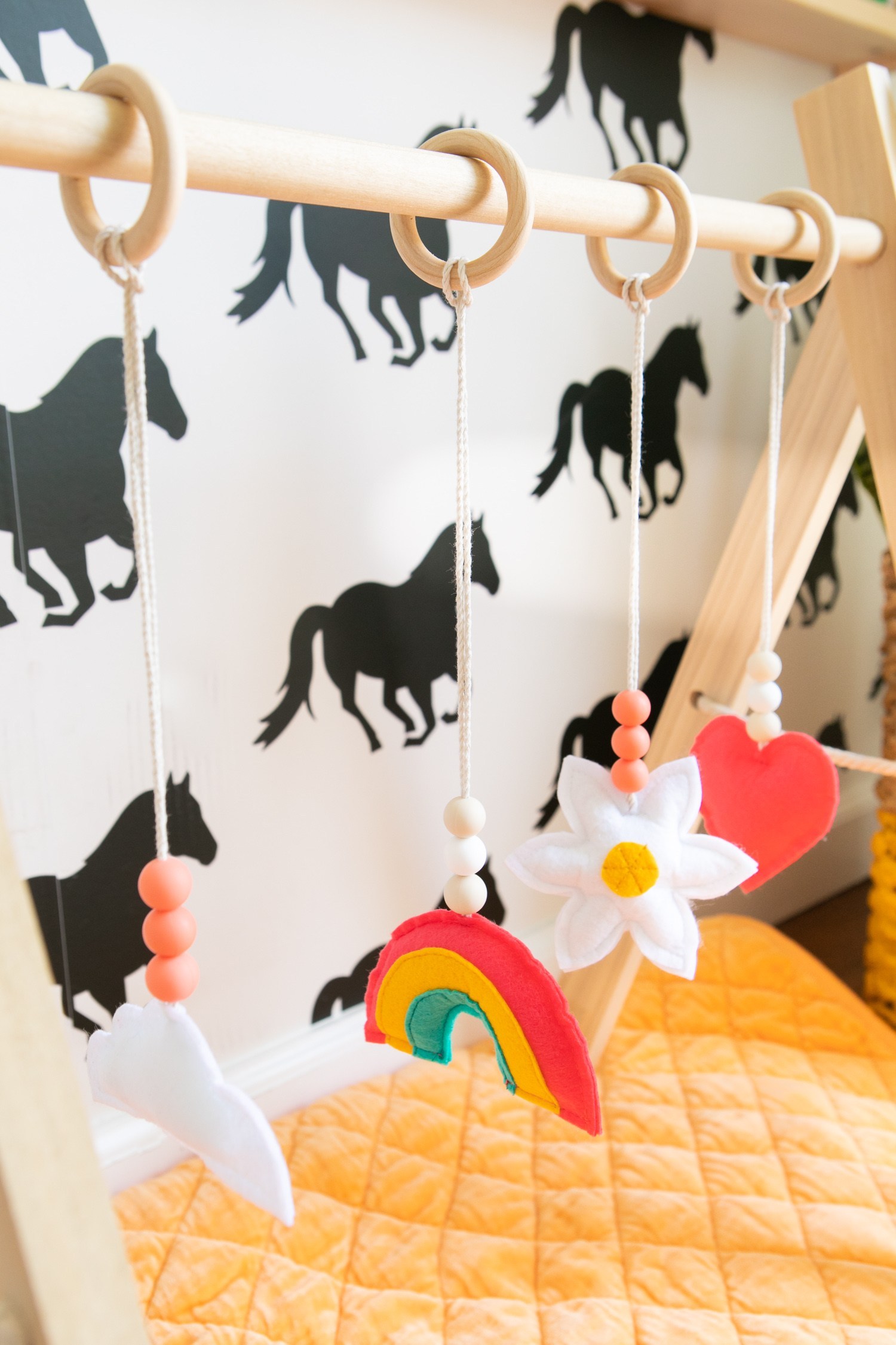 DIY baby gym with colorful sewn toys