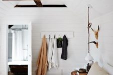 11 white wooden plank walls contrast dark wooden beams creatign a welcoming farmhouse bedroom