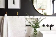 26 popular subway tiles are paired with a black wall and highlighted with black grout for a cool look