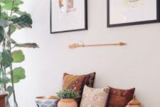 a black bench, printed folksy pillows, potted plants, and a mini gallery wall compose a quirky and chic space