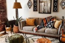 a boho living room with folksy artworks and pillows, leather and velvet ottomans, potted plants and a comfy sofa