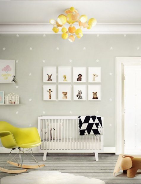a bright nursery in grey, white and bright yellow, a gallery wall, a neon yellow chair and star print wallpaper