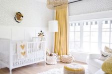 a bright nursery in white and yellow, with a fluffy rug, a colorful ottoman and baskets for storage