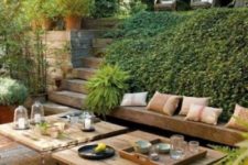 a contemporary meets rustic terrace with a built-in bench, wicker ottomans and low wooden tables