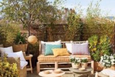 a contemporary rustic patio with a wooden screen, simple wooden furniture and jute and wicker elements