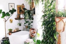 a modern meets boho bathroom with plants in hanging pots, a soak tub, wooden shelves and a bold boho rug