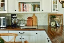 a neutral farmhouse kitchen with white beadboard cabinets, butcherblock countertops and a tile backsplash