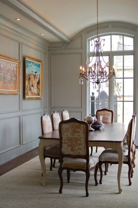 a refined vintage space with light grey paneling up to the ceiling for a sophisticated feel