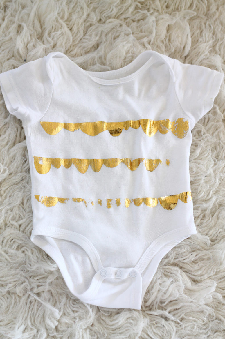 DIY distressed gold foil onesie (via squirrellyminds.com)