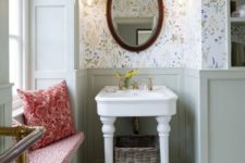 light green wainscoting plus delicate floral wallpaper make up a chic farmhouse bathroom