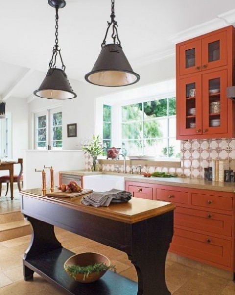 a bold fall kitchen in rust color with a rustic aubergine kitchen island make up a unique color combo with a fall feel