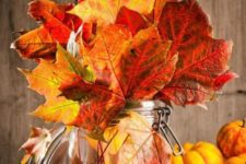 06 a jar with bright fall leaves is a cool centerpiece or just fall decoration idea you may easily make