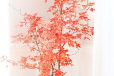 08 super bright red leaves on branches, a metal churn and some pumpkins will make a bold fall statement