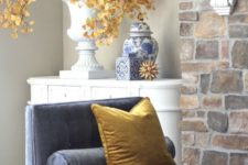 10 bright fall leaf branches in a large vintage urn are a creative and stylish idea for fall decor