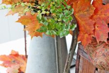 12 an antique metal jug with fall leaves and greenery for home decor is a great idea for a rustic space