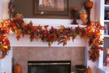 14 a bright fall leaf garland with lights over the mantel is a classic idea for stylish and simple fall decor