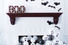 18 a fun fireplace with lots of black and white balloons and bats over it will be loved by both kids and adults