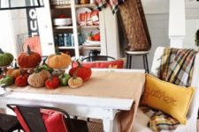 22 colorful velvet pumpkins and checked blankets take over this space and bring a fall feel