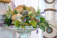 23 a bright velvet pumpkin arrangement with faux greneery, blooms and foliage in a vintage stone urn