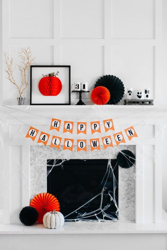 last minute Halloween mantel with paper fans, a 3D artwork, numbers, branches and spiderwebs