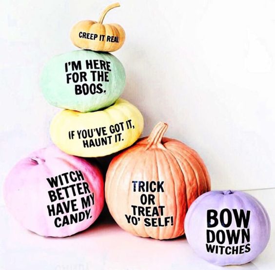 an arrangement of super colorful Halloween pumpkins with funny and whimsy phrases on them for a modern touch