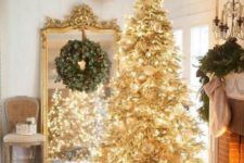 04 a creative gold pre-lit Christmas tree with white ornaments and a faux fur skirt