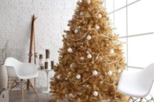06 a gold Christmas tree decorated with white ornaments looks bold and unusual