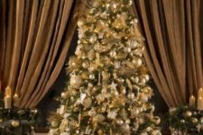 08 a luxurious Christmas tree all covered with gold ornaments, lights and ribbons plus metallic gift boxes