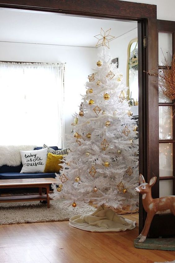 a pure white Christmas tree with gold himmeli and ball ornaments is a bold idea