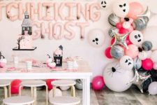 11 pink, white and black Halloween party decor with lots of balloons, letters and haunted houses here and there