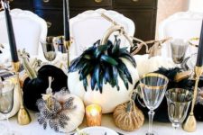 15 a glam black and gold Halloween tablescape with whiet as a base, feathered pumpkins, glitter ones and gold cutlery