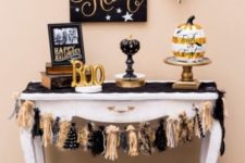 17 a glam dessert table in black and gold, with letters, pumpkins, a garland and a sign – just add treats and voila