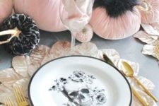 22 a gorgeous glam Halloween tablescape with a skull plate, a leafy placemat, pink velvet pumpkins and touches of black