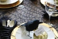 25 an elegant place setting in black and gold, with faux birds and gold pumpkins is a gorgeous idea for a dinner party