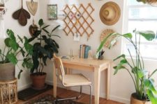 a boho home office nook with hats and decorative baskets, potted plants, a boho rug, a simple desk and a leather chair