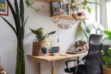 a small boho home office with a simple wooden desk, floating shelves, potted succulents and plants, baskets