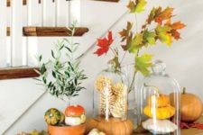 cute displays with natural pumpkins and bleached pinecones placed on a pumpkin is a creative arrangement