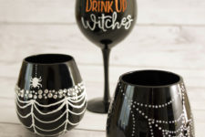 DIY glam black Halloween glasses decorated with rhinestones and white paint