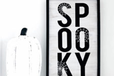 DIY stylish black and white Halloween sign with spiderwebs