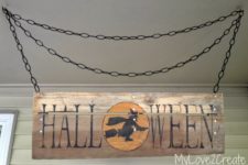 DIY rustic Halloween sign wiht a witch on a broom