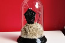 DIY glitter haunted house in a cloche for Halloween decor